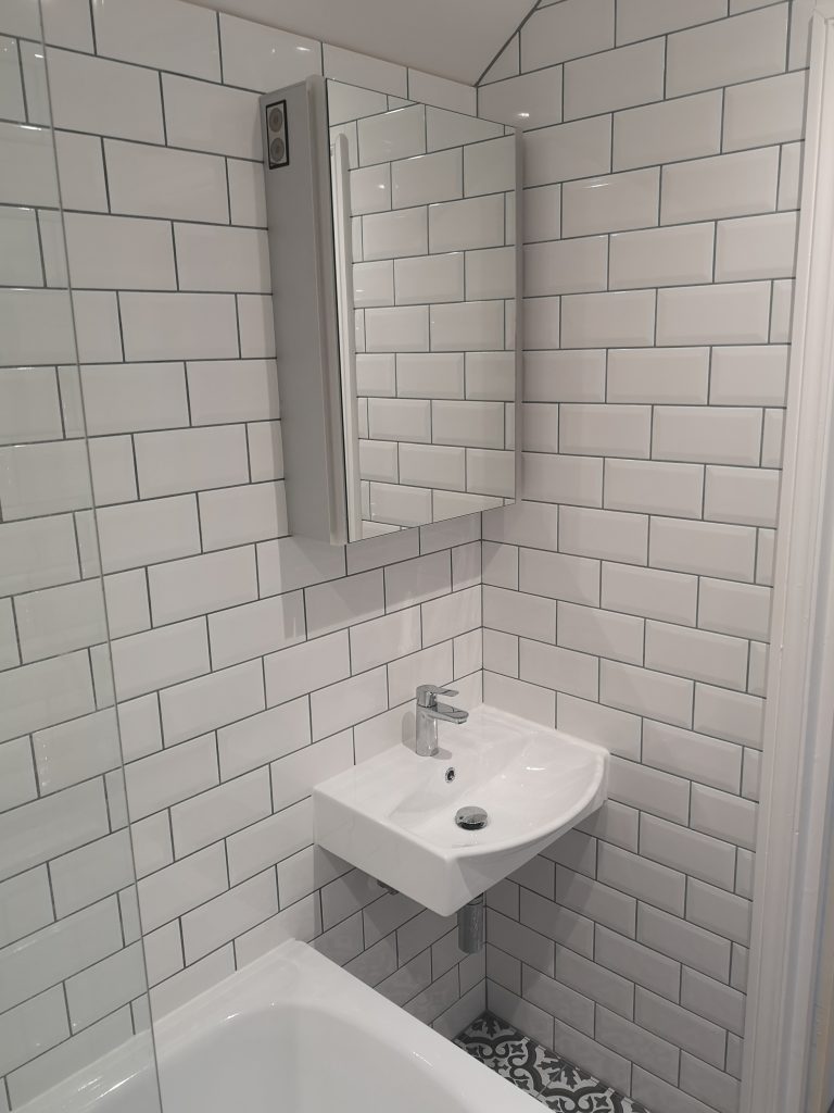 bathroom with white metro tiles and grey grout by south London kitchen and bathroom fitters
